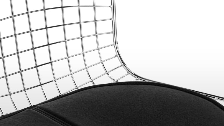 Industrial Yet Refined | Precision-welded of steel wire with a classic leather seat pad, this chair is beloved for its fusion of engineering acumen and everyday comfort.  
