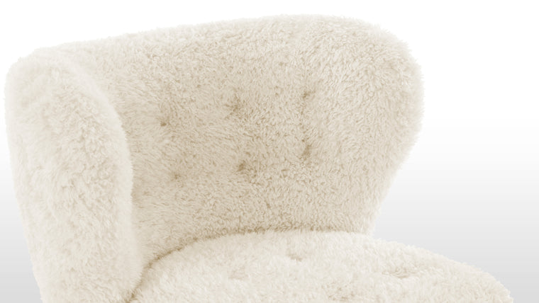 Constructed for Comfort|Cocooned in luxurious vegan sheepskin, the Petra Chair offers an exceptionally cozy and comfortable lounging experience.
