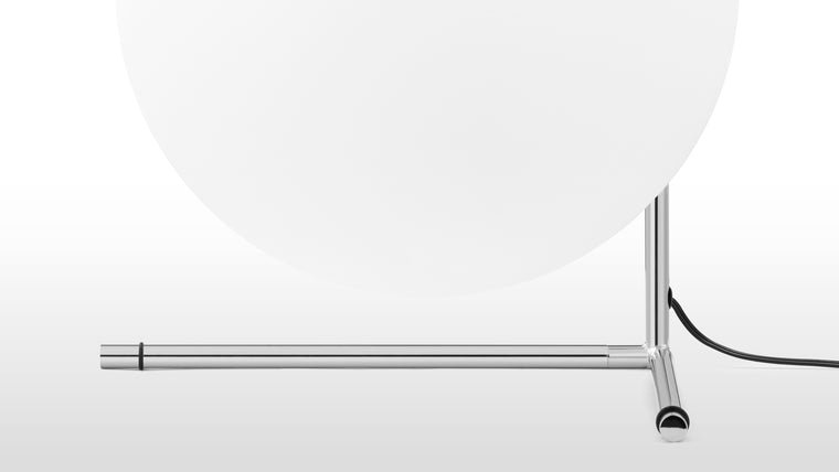 Crafted with Quality | Expertly created with a steel frame and available in brushed brass, chrome and black finishes, this contemporary table lamp is finished with a statement blown-glass opal diffuser, perfectly balanced on its slender stem. The IC T2 Table Lamp is designed to illuminate with a soft, ambient glow.
