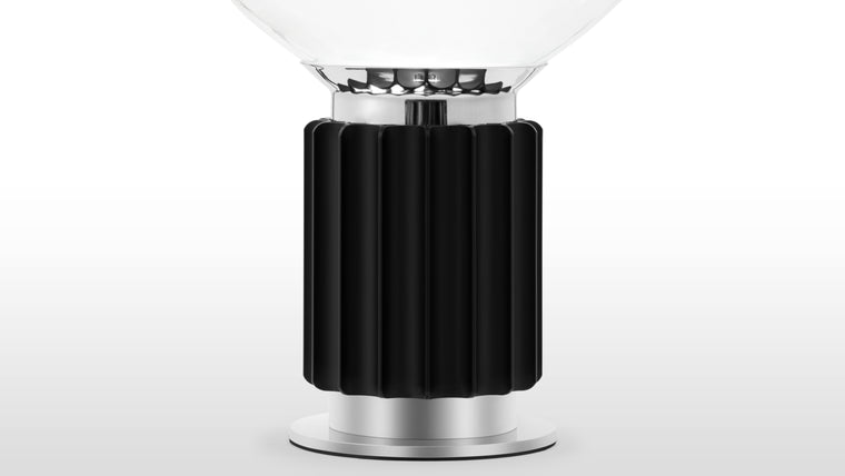 Sculptural Illumination | The Taccia Table Lamp embraces the industrial aesthetic with its raw yet refined materials and bold design. Its robust base showcases the beauty of contrasting textures and industrial-inspired finishes. The sculptural form, reminiscent of an abstract art piece, exudes a sense of modernity and boldness.

