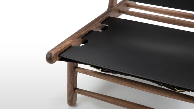 Redefining Lounging | The Hendrik Chair's distinctive and ergonomic design ensures optimal comfort. Its low, reclined seat and sling-like backrest offer a supportive and relaxing seating experience. The wooden armrests add an extra layer of comfort and elegance.
