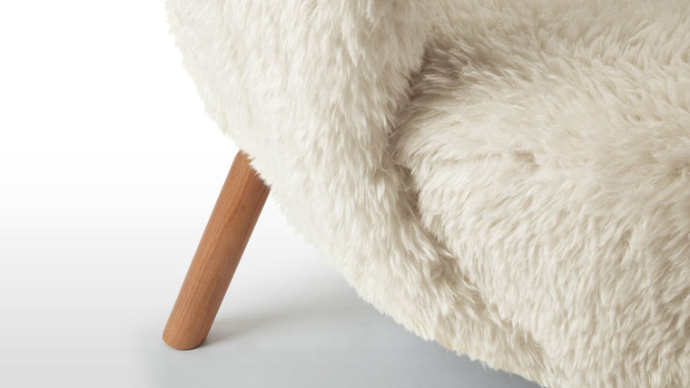 Contemporary Icon | Elevate your living space with the Petra Sofa in white long hair sherpa and oiled walnut. Immerse yourself in its luxurious materials, relish its contemporary design, and indulge in its unparalleled comfort. Create a haven of relaxation and sophistication with this stunning piece of furniture, available at Interior Icons.
