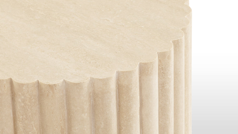Natural Travertine | Crafted from honed natural Italian travertine, this exquisite contemporary end table serves as a striking focal point. With its circular top and a reeded pedestal base, it stands as the perfect choice for discerning homeowners seeking a modern touch of sophistication.
