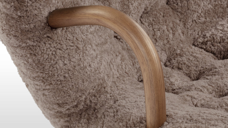 NORDIC DETAILS | Playfully named because of its resemblance to a shell, the Clam chair’s simple, playful form pays homage to Scandinavian design in its honest, understated use of European hardwood and plush upholstery.
