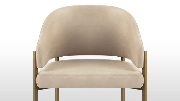 Functional Finesse | The antique brass legs of the Esme Dining Chair add a touch of vintage charm and sophistication. Their warm, burnished finish complements the richness of the upholstery, creating a harmonious interplay of textures and tones.
