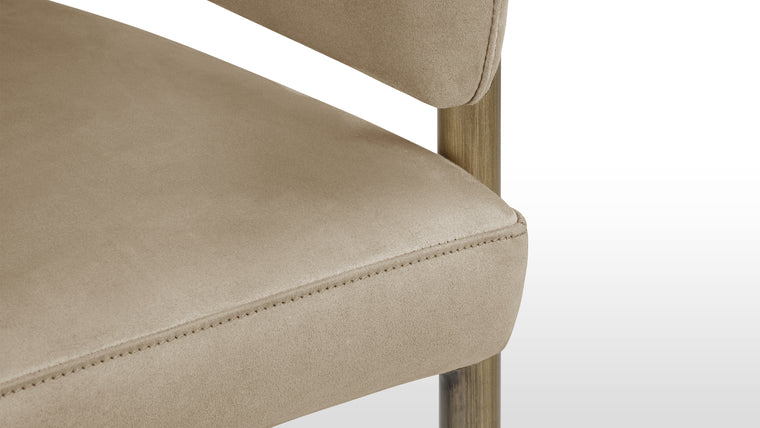 Functional Finesse | The antique brass legs of the Esme Counter Stool add a touch of vintage charm and sophistication. Their warm, burnished finish complements the richness of the upholstery, creating a harmonious interplay of textures and tones.
