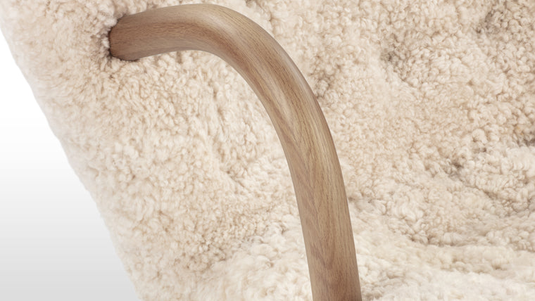 NORDIC DETAILS | Playfully named because of its resemblance to a shell, the Clam chair’s simple, playful form pays homage to Scandinavian design in its honest, understated use of European hardwood and plush upholstery.
