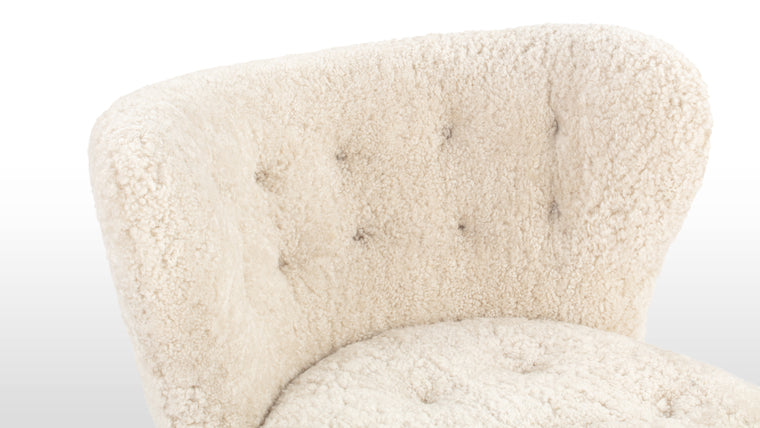 CONSTRUCTED FOR COMFORT | Cocooned in luxurious sheepskin, the Petra Chair offers an exceptionally cozy and comfortable lounging experience.
