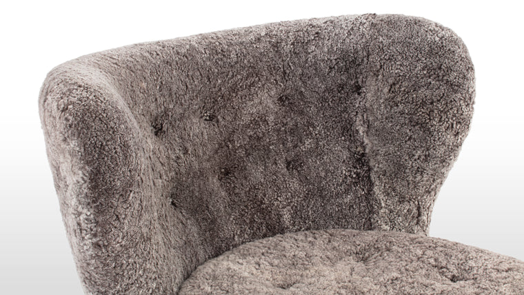 CONSTRUCTED FOR COMFORT | Cocooned in luxurious sheepskin, the Petra Chair offers an exceptionally cozy and comfortable lounging experience.
