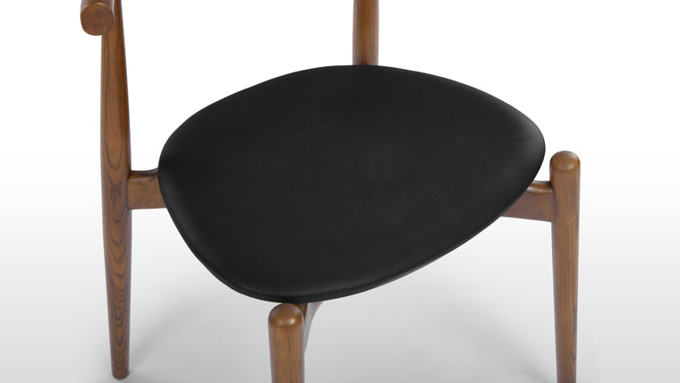 PERFECTLY PRACTICAL | Courtesy of its minimalist silhouette and smart design, the Elbow Chair is lightweight and stackable. Change up your dining and office space effortlessly with this chic seat.
