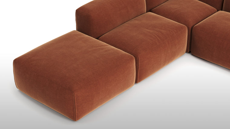 Premium Texture | Available in both neutral-toned fabric and leather or vegan suede, the collection features a foam interior for deep comfort, with understated wooden legs and sleek metal buckles for easy configuration.
