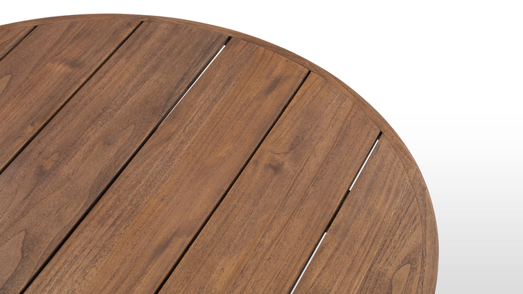 Nature’s Beauty | Showcasing the warmth of natural teak, this table features a round, plank-style tabletop and a sturdy pedestal base for a balanced, minimalistic look. Available in a natural or walnut-stained finish, it adds rustic refinement to any space.
