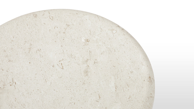 Elegant Simplicity | Crafted from warm limestone, the Valencia Side Table embodies a minimalist aesthetic with its rounded edges and pillar base. Its natural tones and sleek lines exude understated elegance.
