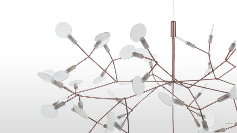 Sculpted Radiance | Crafted from stainless steel with a copper finish, the chandelier’s delicate acrylic shades diffuse the soft LED glow, evoking the ethereal quality of dandelion seeds in flight.

