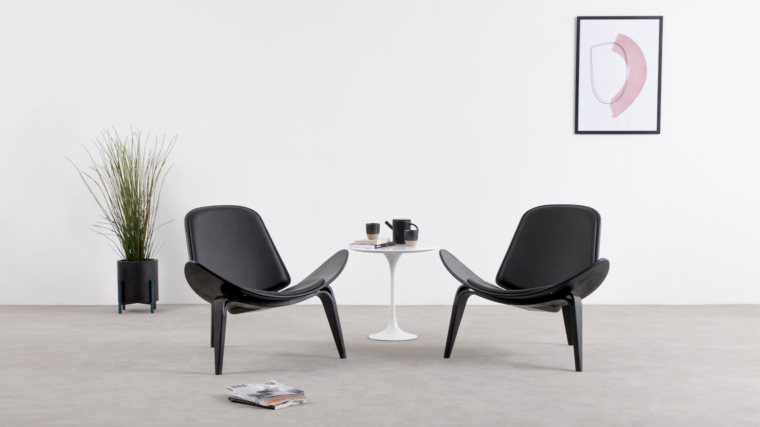A unique design ahead of its time|The Wegner Shell Lounge Chair combines contemporary elements with a futuristic aesthetic. A trio of sleek, hardwearing legs serve as a base for the seemingly weightless, curved seat.
