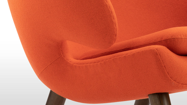 QUINTESSENTIAL QUALITY | Made with luxury Danish wool and walnut legs, this cozy lounge chair is hand-made for a long-lasting, quality finish that assures care is given to the details.
