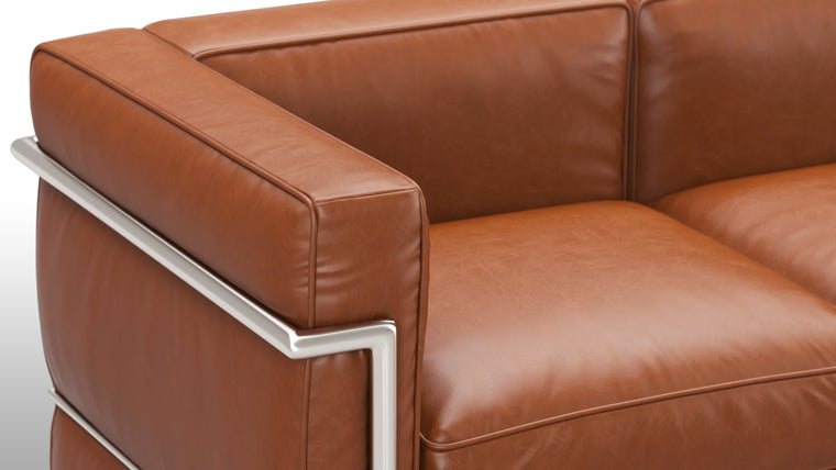 Sleek Frame | The iconic tubular frame design is instantly recognizable and adds a touch of architectural elegance to your space. It not only provides exceptional stability, but also complements the leather upholstery with its polished, minimalist aesthetic. 
