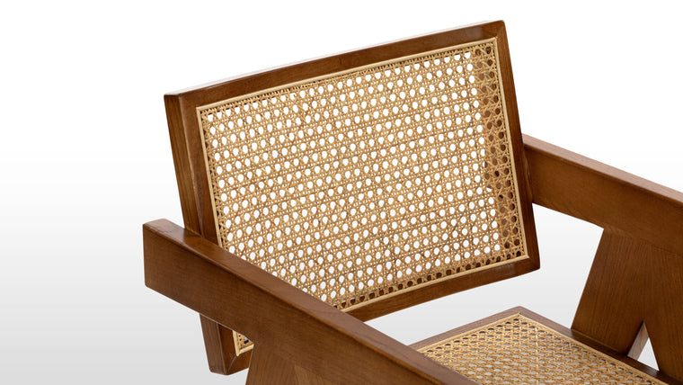 TIMELESS DESIGN | A durable wooden frame, complete with angled legs and tapered armrests, provides the ideal combination for this chair’s comfortable seat and supportive back.
