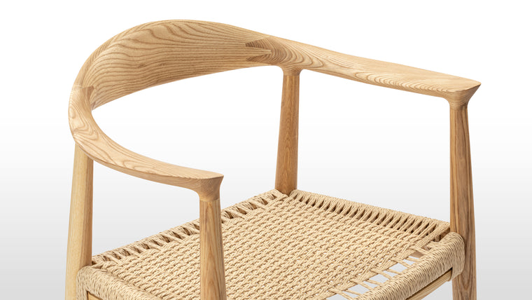Beauty in the Details | The quality of the Wegner Round Chair can be seen in its refined details. From the gentle splay of the back legs to the tapered arm rests, every aspect of the design is finessed. Made from solid Ash with a hand-woven paper cord seat, this chair is made to last; buy for yourself, and hand down to future generations.
