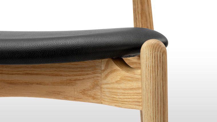 PERFECTLY PRACTICAL | Courtesy of its minimalist silhouette and smart design, the Elbow Chair is lightweight and stackable. Change up your dining and office space effortlessly with this chic seat.
