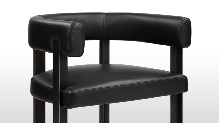 Acute Angles | This iconic chair is defined by its sharp angles and geometric form. The stylish steel legs make a statement, meeting the soft curved backrest at 90 degree angles, giving the design its distinctive 'T' shape and commanding look.
